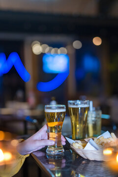food and drink male friends are happy drinking beer and clinking glasses at a bar or pub.