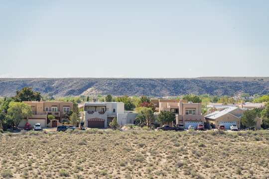 Suburban Houses and Desert Landscape with Distant Volcanic Hills