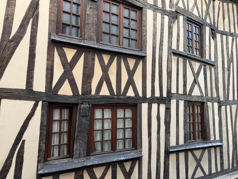 Half-timbered building facade with wooden windows
