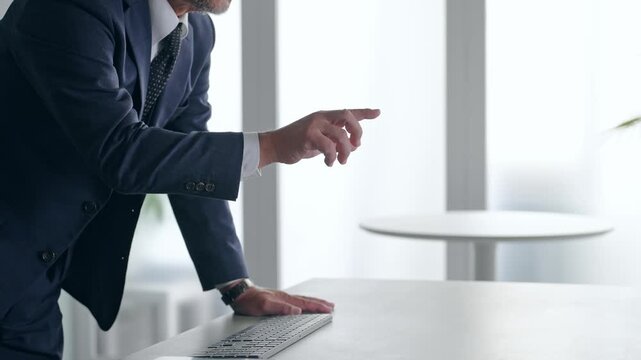 A male businessperson operating a screen in mid-air. VR, virtual, touch, operation, hologram, office, screen