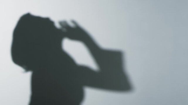 The silhouette of a woman laughing heartily. Laughing, roaring with laughter, comedy, business person, mocking, fun, happy, joyful