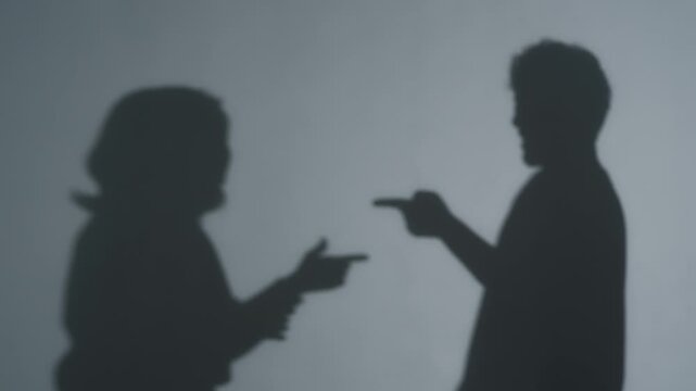 Silhouette of a couple arguing