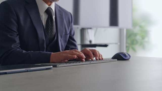 A male business person operating a PC keyboard. Business, DX, IT, programmer, engineer, input