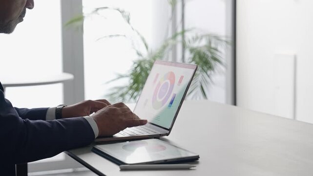 A business person working on a laptop in the office. Desk work, office work, engineer, work.