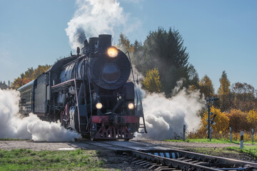 Retro steam train departs from the platform. © serjiob74