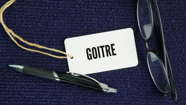 Stethoscope and paper tag with the word Goitre. goitre is an abnormal swelling or enlargement of the butterfly-shaped thyroid gland located at the front of the neck