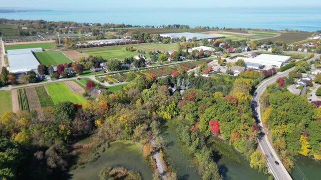 Aerial panning moving forward west from Martindale Pond over Richardson's Creek towards Lake Ontario in north St. Catharines, Ontario, Canada on a sunny Autumn day in October, 2024. Part 2 of 2.