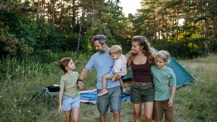 Naklejka premium Happy family spending time together during summer camping trip.
