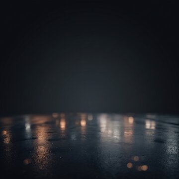 Dark, wet asphalt surface with blurred golden bokeh lights reflecting in the night rain