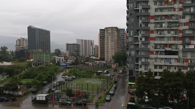 Residential towers rise above Batumi streets in a wide city view, providing location footage for property market analysis, urban development reporting and real estate investment presentations