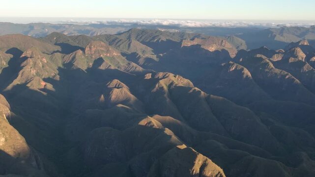 Codo de los Andes Mountain Ridges and Deep Valleys in Warm Golden Light in Bolivia. Establishing Shot. Aerial View.