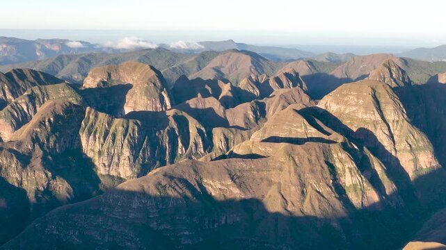 Codo de los Andes Mountain Ridges and Deep Valleys in Warm Golden Light in Bolivia. Establishing Shot. Aerial View.