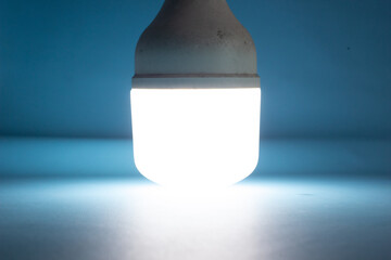 Close-up photo of a white LED light illuminating a dark environment, creating a striking contrast between brightness and shadow. Symbolizes energy efficiency, modern lighting technology, visibility,  © bizdof photo