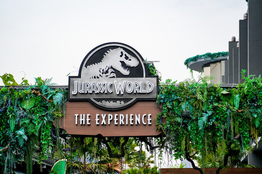 Jurassic World The Experience entrance sign surrounded by tropical greenery at a dinosaur-themed attraction in Bangkok, Thailand, Bangkok, April 26, 2026.