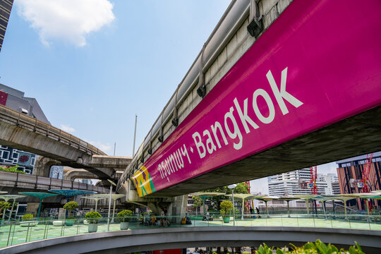 BTS Skytrain passes through central Bangkok with modern glass office towers and the MahaNakhon skyscraper rising in the background, Thailand, Bangkok, April 26, 2026.