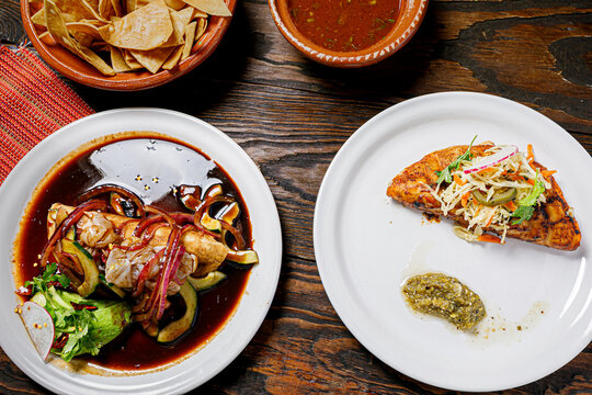 Black aguachile with shrimp and grilled fish fillet with slaw, Mexican seafood table top view