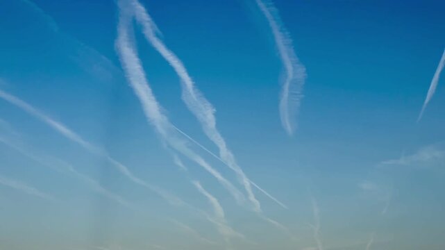 Blue sky with airplane trails