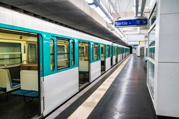 Fototapeta premium Train at Mairie d'Aubervilliers metro station in Paris, France on July 20, 2022.