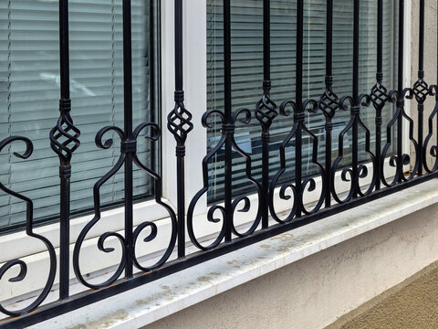 Wrought iron security bars on residential window exterior