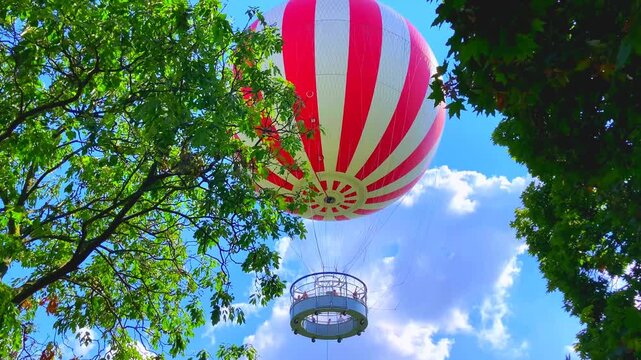 BUDAPEST, HUNGARY - AUGUST 31, 2025: BalloonFly in Budapest's City Park (Varosliget). Floats gently above Budapest's City Park, offering an open-air viewpoint that rises up to 150 meters into the sky