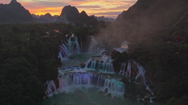 Magnificent aerial view of the ban gioc detian falls on the border of vietnam and china. Breathtaking landscape with water and mist at dusk