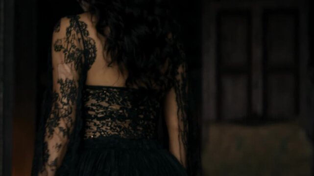 Woman in sugar skull makeup turns to reveal black lace Halloween costume. Dia de los Muertos fantasy fashion. Halloween party costume. Gothic portrait and beauty