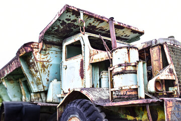 Old rusty mining dump truck abandoned on white background, representing vintage industrial machinery, heavy equipment rust, scrap metal decay, and mining machinery history. © chaiwat
