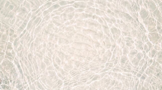 Top view of clear shallow water surface with light caustics ripples