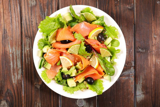 Smoked salmon salad with avocado lemon and black olives top