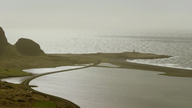 L&oacute;n Lagoon at Hvalnes Nature Reserve, Hornafjordur, East Iceland, Iceland, lies behind a coastal barrier beside the Atlantic shoreline, drone descent