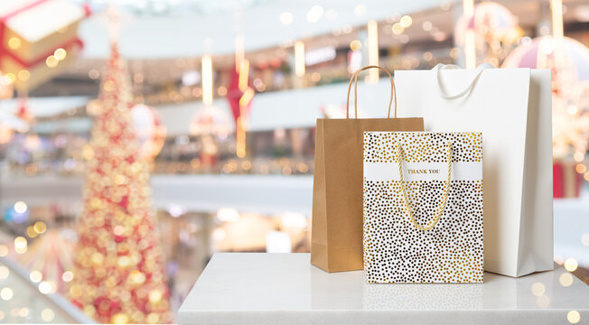 Shopping bags on marble counter with blurred mall background