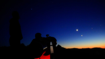 Fototapeta premium Amateur astronomers observing stars, planets, Moon and other celestial objects with a telescope in nature.