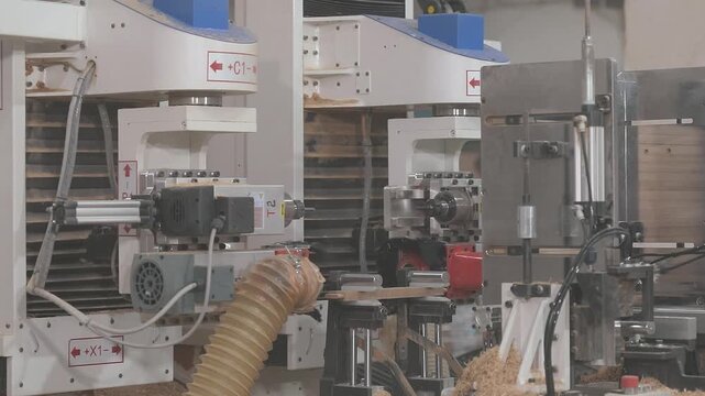 CNC woodworking machine milling a precision edge profile on a wooden board. Automated routing process creates an interlocking joint for furniture manufacturing. Industrial interior 