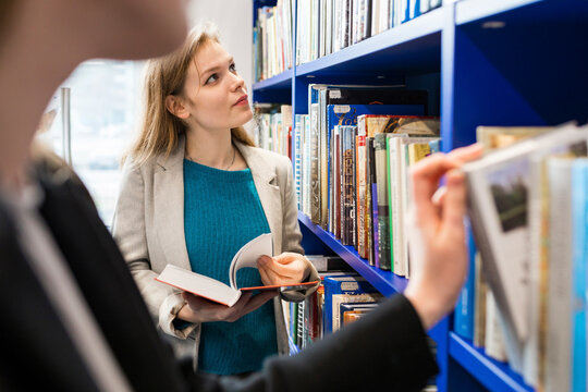 Teenage girl choosing books in a public library
