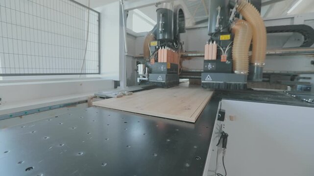 CNC Machine Processing Chipboard Panels at Furniture Factory. Automated CNC Machine Processing Chipboard Panels, particleboard panels, particle boards