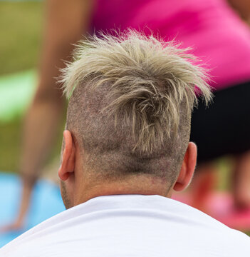 Close-up of person with spiky, fading blonde hair