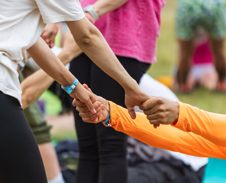 Hands clasped together in a supportive group gesture