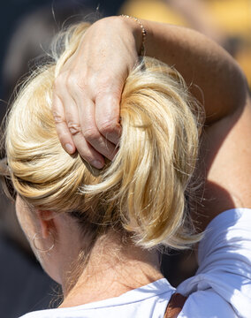 Golden hair tied in a loose bun