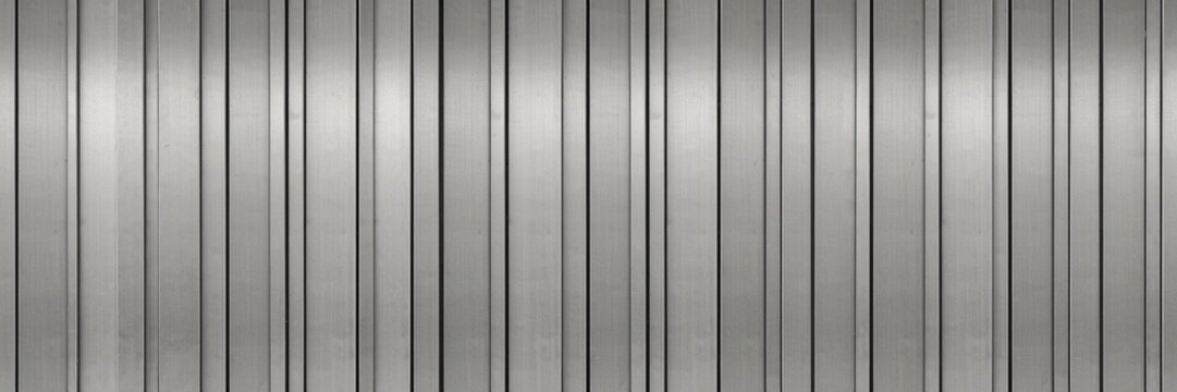 background Silver corrugated metal sheet panel texture, industrial steel wall siding surface background, grey metallic ribbed tin fence pattern for architectural design
