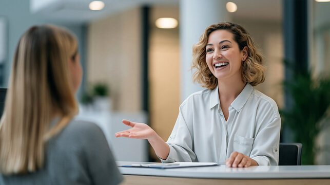 Young woman engaging client, offering guidance and a warm welcome in a contemporary business environment