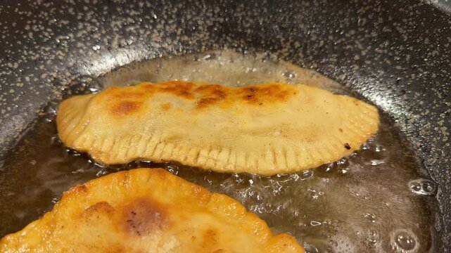 Golden Cheburek Frying in Sizzling Oil, Crispy Fried Meat Pastry in Pan