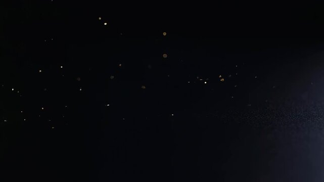 Glowing particles drift through a dark atmospheric space-like field. Cinematic title, technology presentation, and science media.