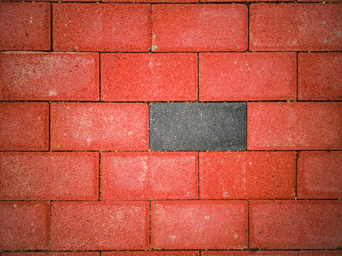 Red floor tiles with gray tiles embedded in between