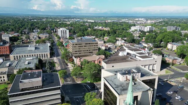 Aerial city looking south moving back reveal shot over Church Street from downtown St. Catharines, Ontario, Canada on a summer morning in August, 2024.
