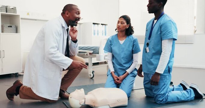 Talking, cpr and doctor with students for learning first aid, safety protocol or medical support. Healthcare, team and man with nurses in paramedic course for cardiac arrest, rescue or emergency care