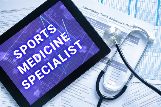 SPORTS MEDICINE SPECIALIST text on digital tablet screen with stethoscope and documents