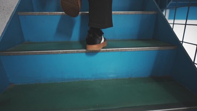 Walking Up Blue Stairs in an Urban Environment
