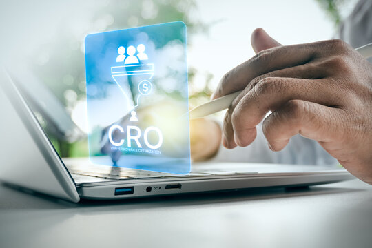 Businessman using laptop with digital Conversion Rate Optimization CRO marketing funnel interface in outdoor setting, concept of sales funnel strategy and lead generation.