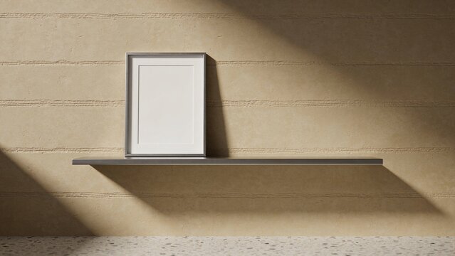 Leaning white picture frame on slim shelf in gallery, textured wall casting speckled floor shadows