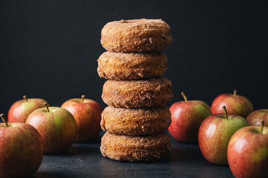 Apple cider donuts stacked with fresh apples autumn fall bakery seasonal dessert